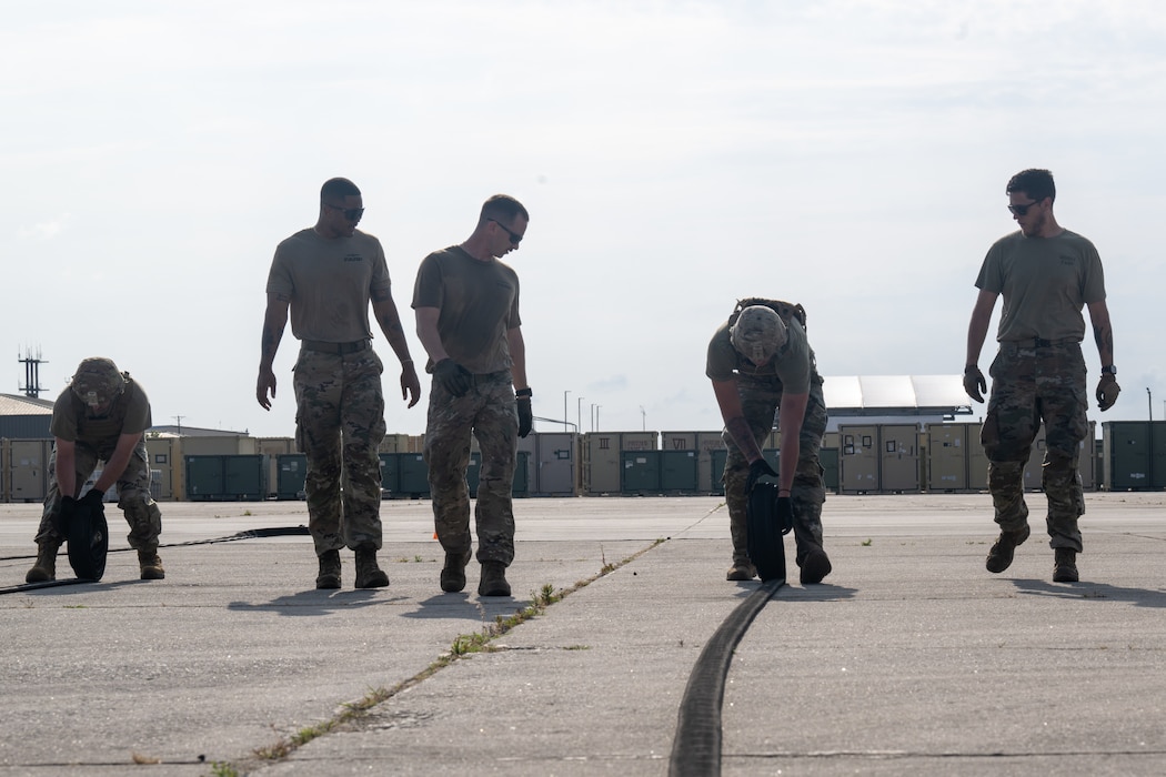 U.S. Air Force Airmen assigned to the 23rd Logistics Readiness Squadron Forward Area Refueling Point (FARP) team motivate potential candidates during the FARP team tryout at Moody Air Force Base, Georgia, May 9, 2025. Current members of the FARP team will run with candidates and motivate them as they try out, occasionally giving them hints if they get stuck. (U.S. Air Force photo by Airman 1st Class Iain Stanley)