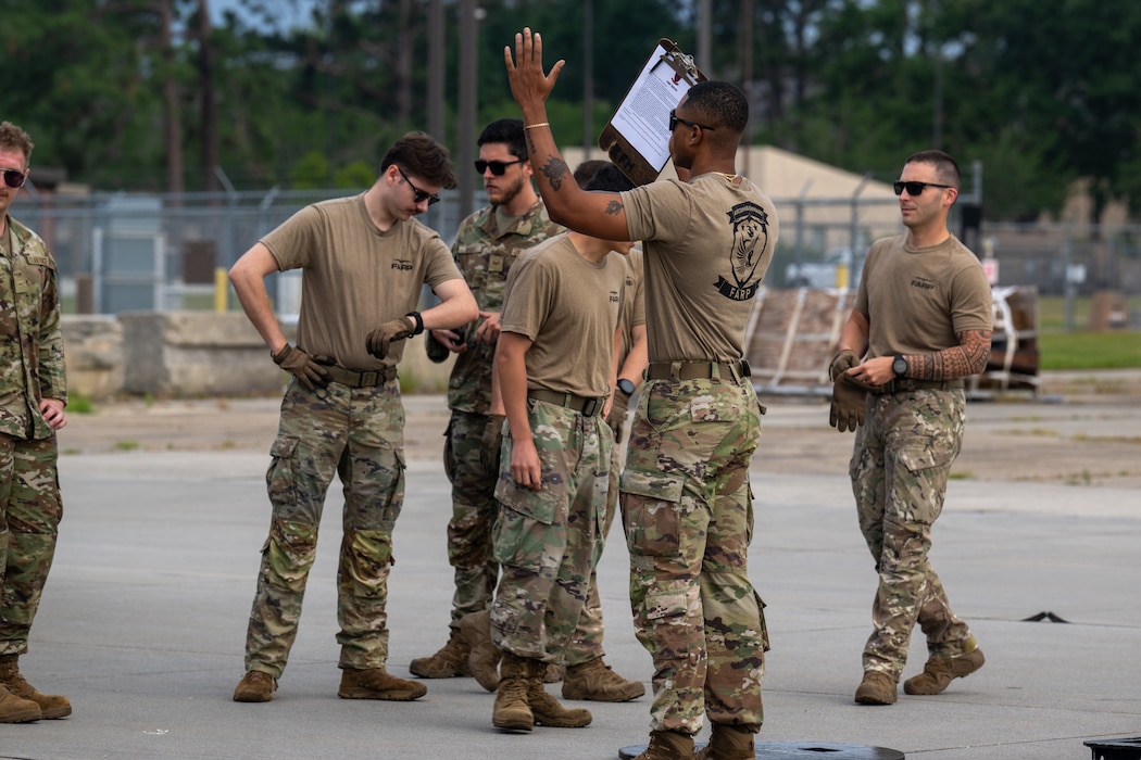 U.S. Air Force Airmen assigned to the 23rd Logistics Readiness Squadron Forward Area Refueling Point (FARP) team explain the FARP tryout to potential members at Moody Air Force Base, Georgia, May 9, 2025. The FARP team demonstrated their ability to perform rapid refueling of aircraft in austere conditions. (U.S. Air Force photo by Airman 1st Class Iain Stanley)