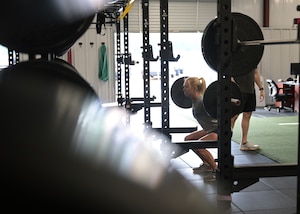 An Airman performs a weighted squat during a CRAFT demonstration