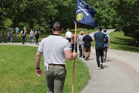 Officer Candidate Parker Meads carries the company guidon as Illinois Army National Guard Officer Candidate School students conduct a staff ride at Fort Donelson National Battlefield, Tennessee, May 17, 2025.