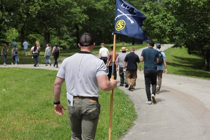 Officer Candidate Parker Meads carries the company guidon as Illinois Army National Guard Officer Candidate School students conduct a staff ride at Fort Donelson National Battlefield, Tennessee, May 17, 2025.