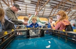 James Parkhurst, work leader, Shop 64, Woodworkers, Shipwrights, Insulators and Plastic fabricators, demonstrates how dry docks work May 14, 2025, during the 2025 Kitsap Water Festival at the Kitsap County Fairgrounds in Bremerton, Washington. (U.S Navy photos by Wendy Hallmark)