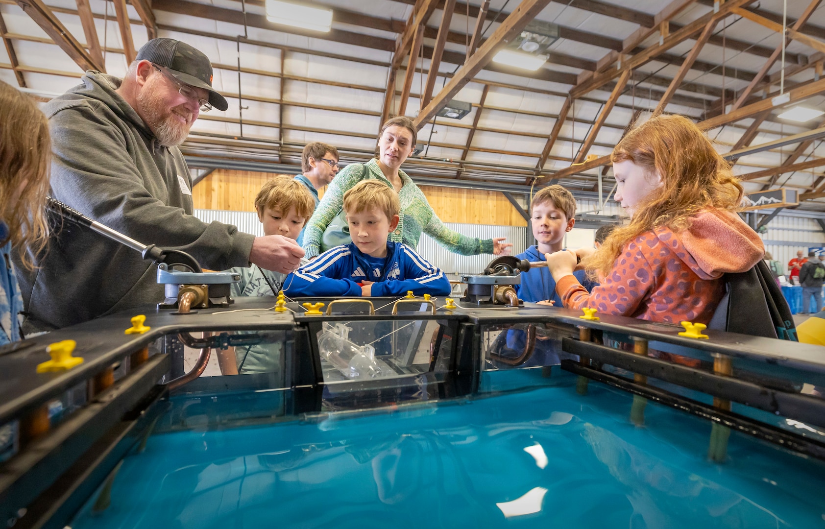 James Parkhurst, work leader, Shop 64, Woodworkers, Shipwrights, Insulators and Plastic fabricators, demonstrates how dry docks work May 14, 2025, during the 2025 Kitsap Water Festival at the Kitsap County Fairgrounds in Bremerton, Washington. (U.S Navy photos by Wendy Hallmark)