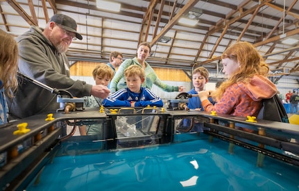 James Parkhurst, work leader, Shop 64, Woodworkers, Shipwrights, Insulators and Plastic fabricators, demonstrates how dry docks work May 14, 2025, during the 2025 Kitsap Water Festival at the Kitsap County Fairgrounds in Bremerton, Washington. (U.S Navy photos by Wendy Hallmark)