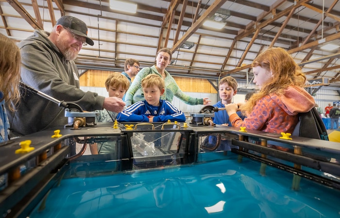James Parkhurst, work leader, Shop 64, Woodworkers, Shipwrights, Insulators and Plastic fabricators, demonstrates how dry docks work May 14, 2025, during the 2025 Kitsap Water Festival at the Kitsap County Fairgrounds in Bremerton, Washington. (U.S Navy photos by Wendy Hallmark)