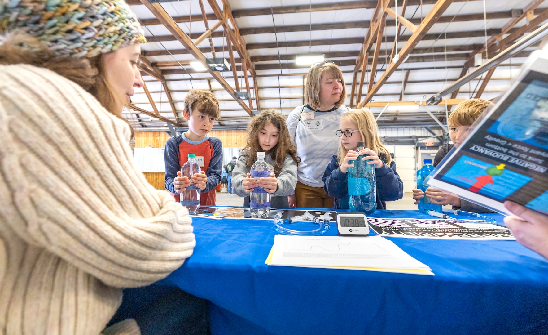 Valerie Johnson, education specialist, Naval Undersea Museum, Keyport, teaches a group of students about buoyancy and compressibility in submarines, May 14, 2025, during the 2025 Kitsap Water Festival at the Kitsap County Fairgrounds in Bremerton, Washington. (U.S. Navy photo by Wendy Hallmark)