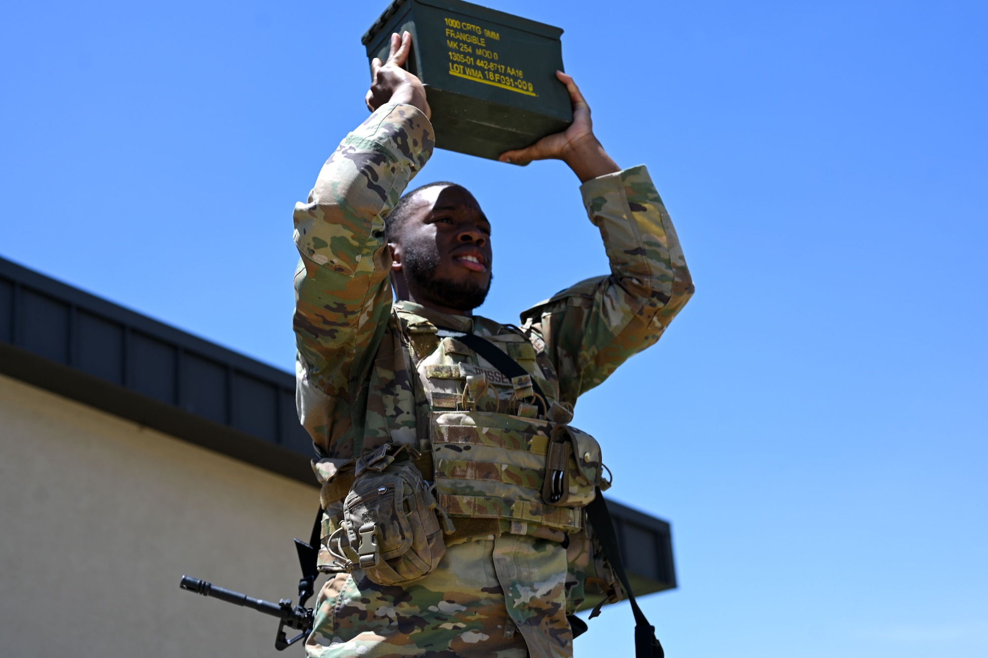 U.S. Air Force Senior Airman David Russell, 17th Security Forces Squadron Defender, lifts an ammo crate as part of the Security Forces Shooting Competition at Goodfellow Air Force Base, Texas May 13, 2025. Participants completed a series of physical exercises, as well as attempting to have the highest qualification on both the M4 and M18 weapon systems.  (U.S. Air Force photo by Senior Airman Evelyn J. D’errico)