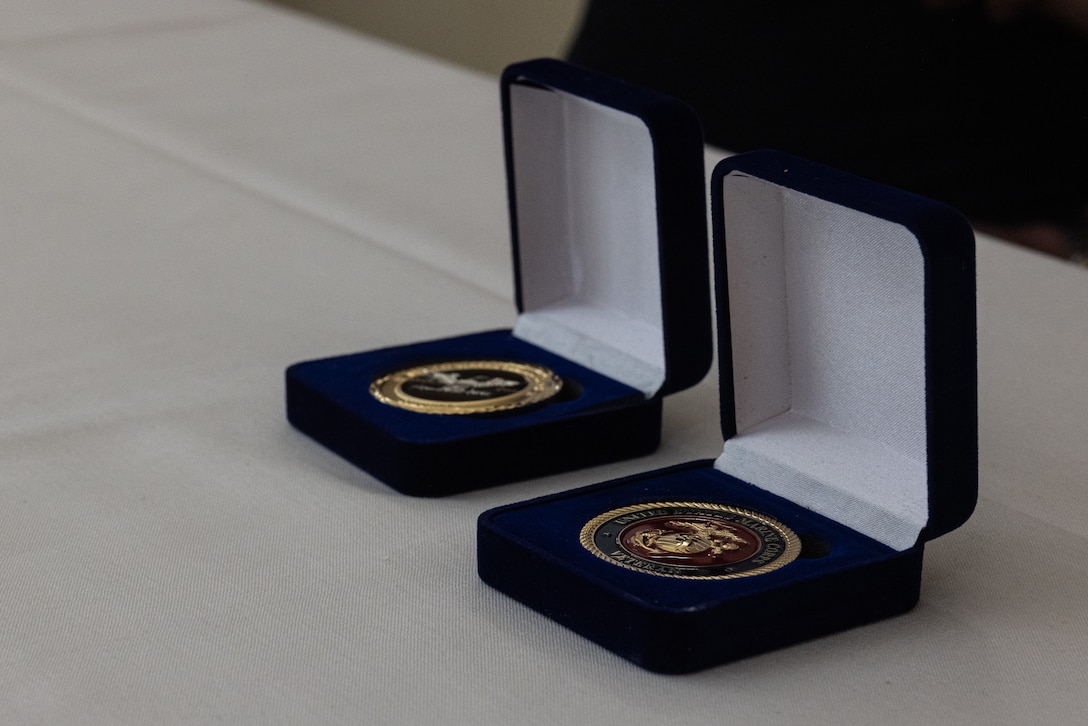 Challenge coins sit on a table at a surprise birthday celebration for Retired Col. George Newton at the Silvergate Assisted Living Center in Fallbrook, Calif., April 27, 2025. Silvergate Assisted Living Center hosted a surprise celebration for Newton’s 100th birthday with over 20 active duty and retired Marines. Newton is a World War II, Korean War, and Vietnam War veteran. (U.S. Marine Corps photo by Cpl. Jacqueline Akamelu)