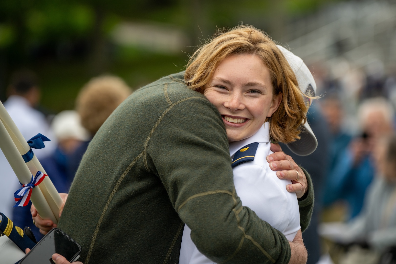 U.S. Coast Guard Academy (USCGA) Cadet First Class Gustava Elizabeth Engeman Drew embraces a loved one following the 144th Commencement Exercises. USCGA commissioned approximately 260 new officers. (U.S. Coast Guard photo by Petty Officer Third Class Leo Avila.)