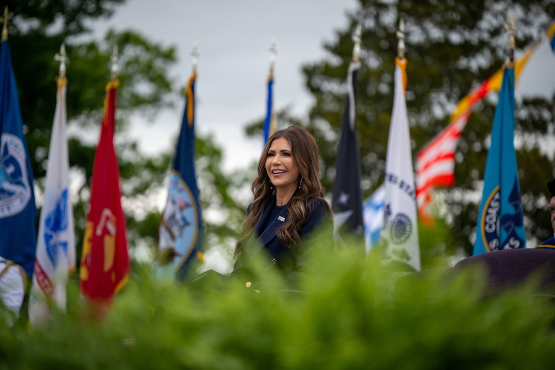 Secretary of Homeland Security Kristi Noem speaks during the 144th Commencement Exercises at the U.S. Coast Guard Academy, New London, Connecticut, May 21, 2025. Noem shared the details of Force Design 2028, which includes plans to purchase new aircraft, grow the workforce by 15,000 people, fix aging facilities, and begin a once-in-a-generation transformation of the 234-year old maritime service. (U.S. Coast Guard photo by Petty Officer Third Class Leo Avila.)