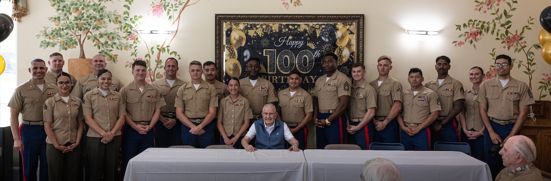 U.S. Marines gather for a group photo with Retired Col. George Newton at the Silvergate Assisted Living Center in Fallbrook, Calif., April 27, 2025. Silvergate Assisted Living Center hosted a surprise celebration for Newton’s 100th birthday with over 20 active duty and retired Marines. Newton is a World War II, Korean War, and Vietnam War veteran. (U.S. Marine Corps photo by Cpl. Jacqueline Akamelu)