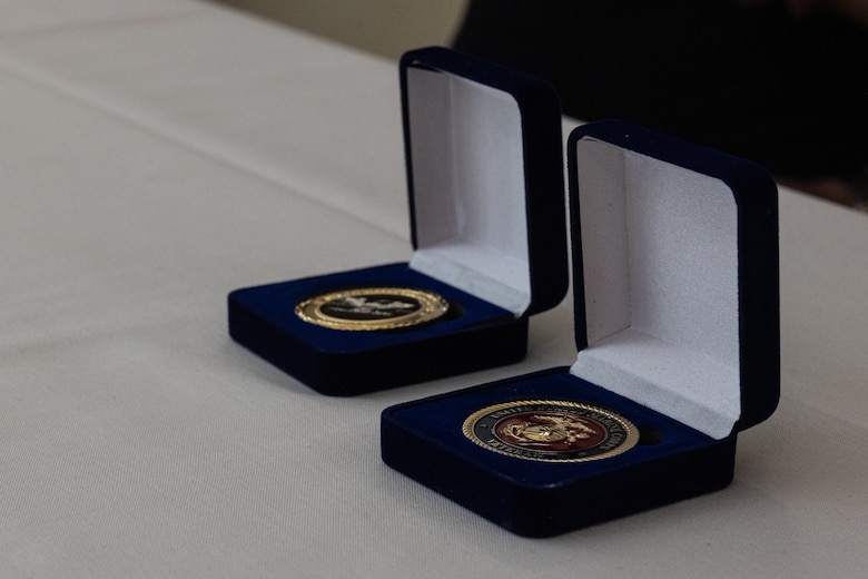 Challenge coins sit on a table at a surprise birthday celebration for Retired Col. George Newton at the Silvergate Assisted Living Center in Fallbrook, Calif., April 27, 2025. Silvergate Assisted Living Center hosted a surprise celebration for Newton’s 100th birthday with over 20 active duty and retired Marines. Newton is a World War II, Korean War, and Vietnam War veteran. (U.S. Marine Corps photo by Cpl. Jacqueline Akamelu)