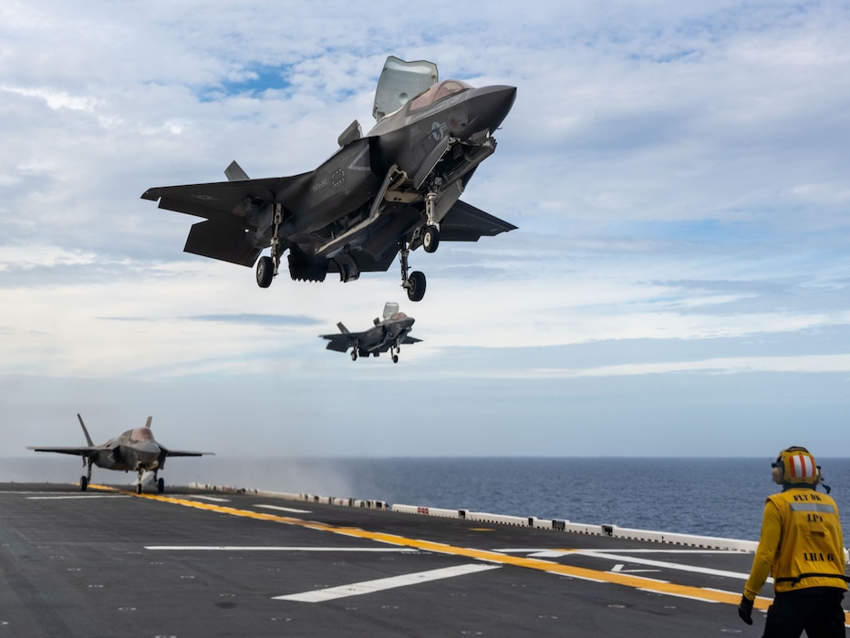 Two F-35B Lightning II fighter aircrafts from Marine Fighter Attack Squadron (VMFA) 242, prepare to land on the flight deck the forward-deployed amphibious assault ship USS America (LHA 6) while conducting flight operations in the East China Sea, May 20.