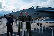 Senior Chief Aviation Electrician's Mate Richard Tretsven, left, and Aviation Electrician's Mate Second Class Marcus Cox pose for a photo in front of an F/A-18E Super Hornet from the “Kestrels” of Strike Fighter Squadron (VFA) 137 with an attendee at the Langkawi International Maritime and Aerospace Exhibition 2025 in Langkawi, Malaysia, May 20, 2025. LIMA 25 is a biennial event that brings together industry stakeholders and government and military leaders from more than a dozen nations for a five-day event dedicated to the maritime and aerospace sectors for defense, civil and commercial applications. (U.S. Air Force photo by Senior Airman Alexzandra Gracey)