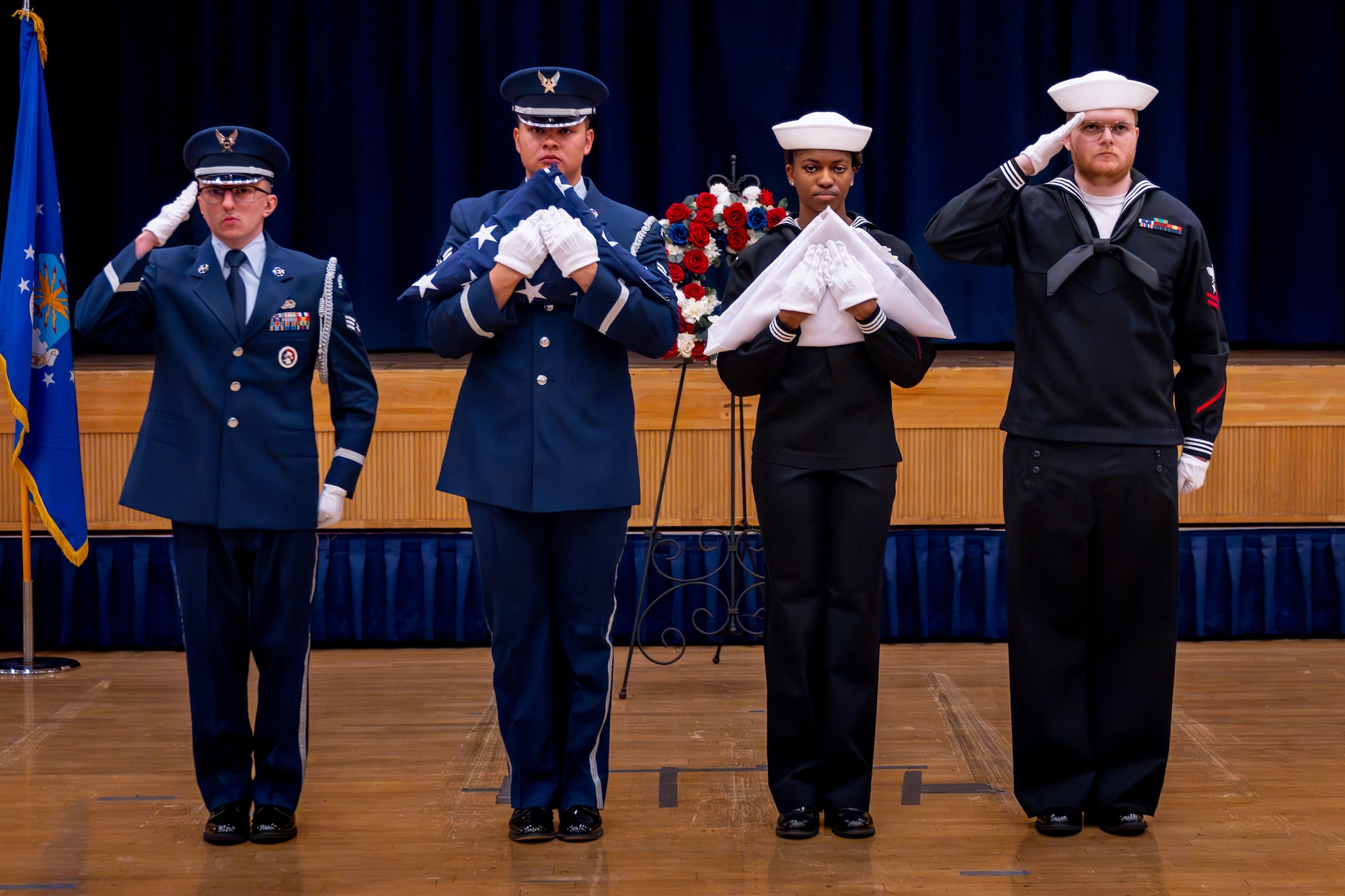Honor Guard members salute service members.