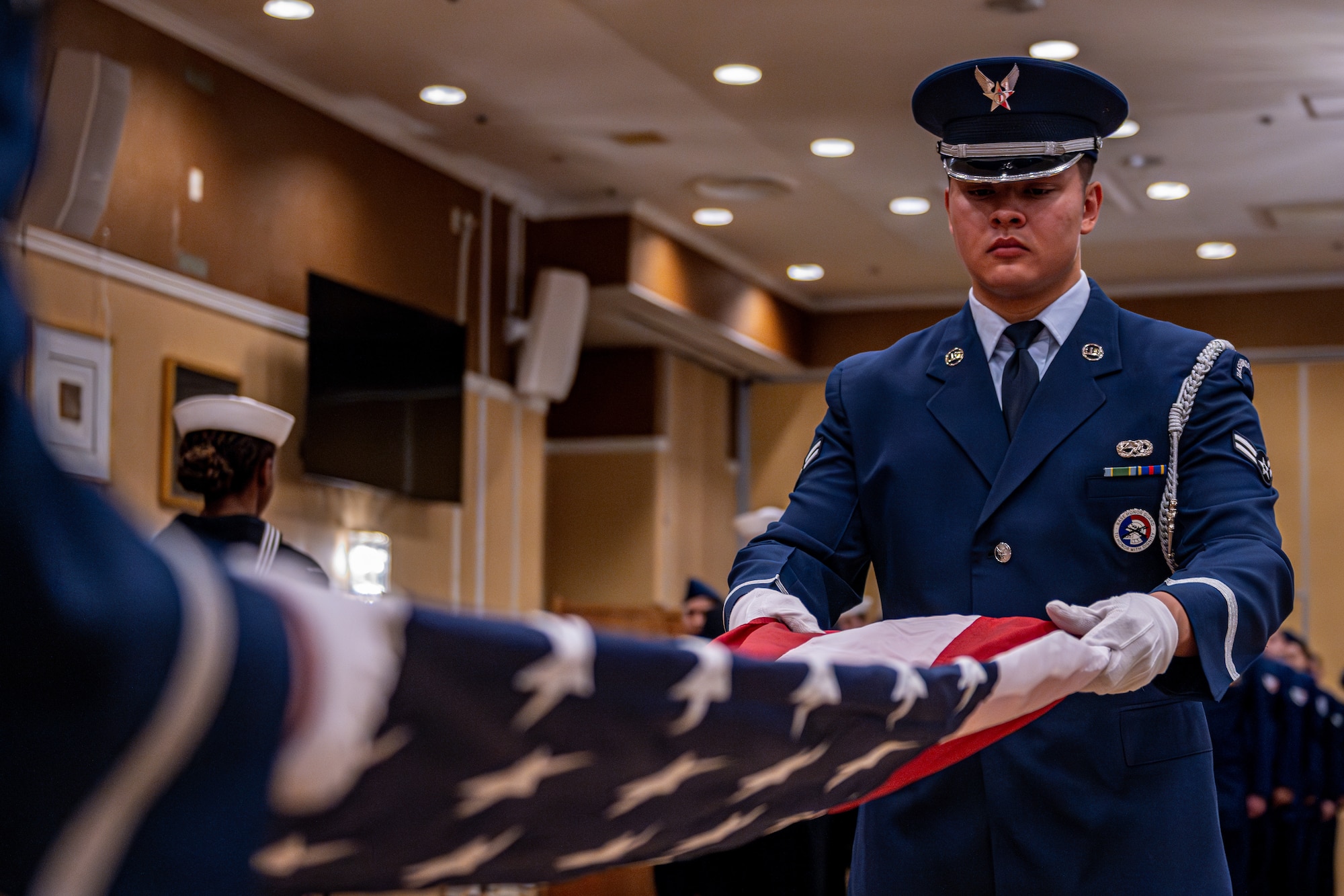 Honor Guard folds American flag.