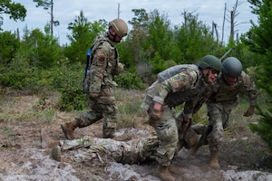 U.S. Air Force Airmen assigned to the 21st Air Task Force transport a simulated casualty during exercise CHAOS RISING at a Combat Support Training Range location, Tyndall Air Force Base, Florida, May 9, 2025. This rigorous training ensured 21st ATF Airmen are mission ready by honing capabilities that enable operating from smaller, dispersed locations to generate and sustain combat airpower. (U.S. Air Force photo by Senior Airman Alondra Cristobal Hernandez)