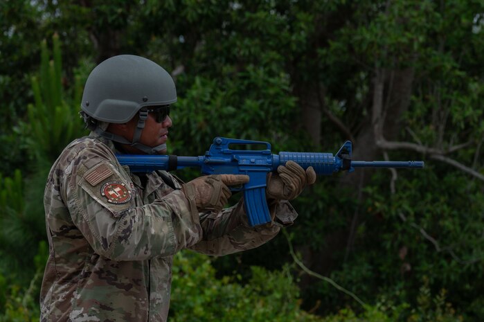 U.S. Air Force Staff Sgt. Kevin Blevins, 96th Medical Support Squadron healthcare technician and tactical combat casualty care instructor, draws his weapon during a force protection course at Tyndall Air Force Base, Florida, May 9, 2025. The Air Task Force exercise CHAOS RISING emphasized achieving proficiency in Agile Combat Employment by executing operations from dispersed and austere environments. (U.S. Air Force photo by Senior Airman Alondra Cristobal Hernandez)