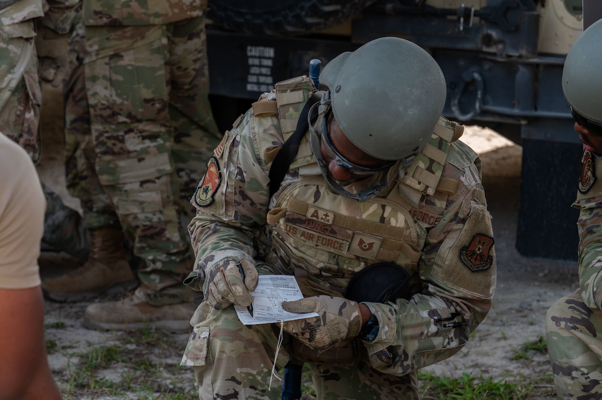 U.S. Air Force Tech. Sgt. Marcus Toney, 7th Civil Engineer Squadron requirements and optimization section chief, prepares a Tactical Combat Casualty Care medical card during exercise CHAOS RISING at a Combat Support Training Range location, Tyndall Air Force Base, Florida, May 9, 2025. The 21st Air Task Force exercise focused on proficiency in Agile Combat Employment by executing operations from dispersed and austere environments. (U.S. Air Force photo by Senior Airman Alondra Cristobal Hernandez)