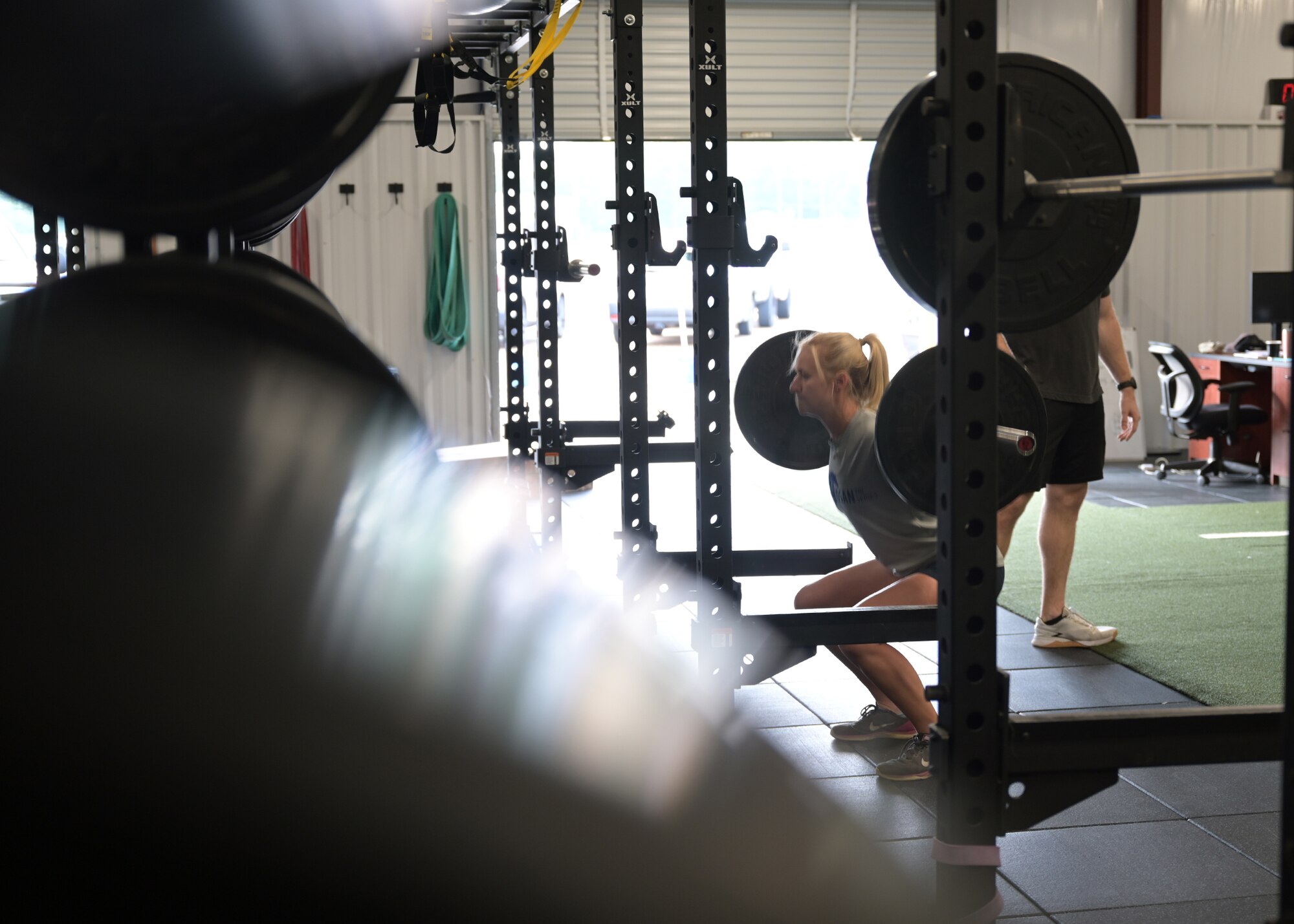 An Airman performs a weighted squat during a CRAFT demonstration