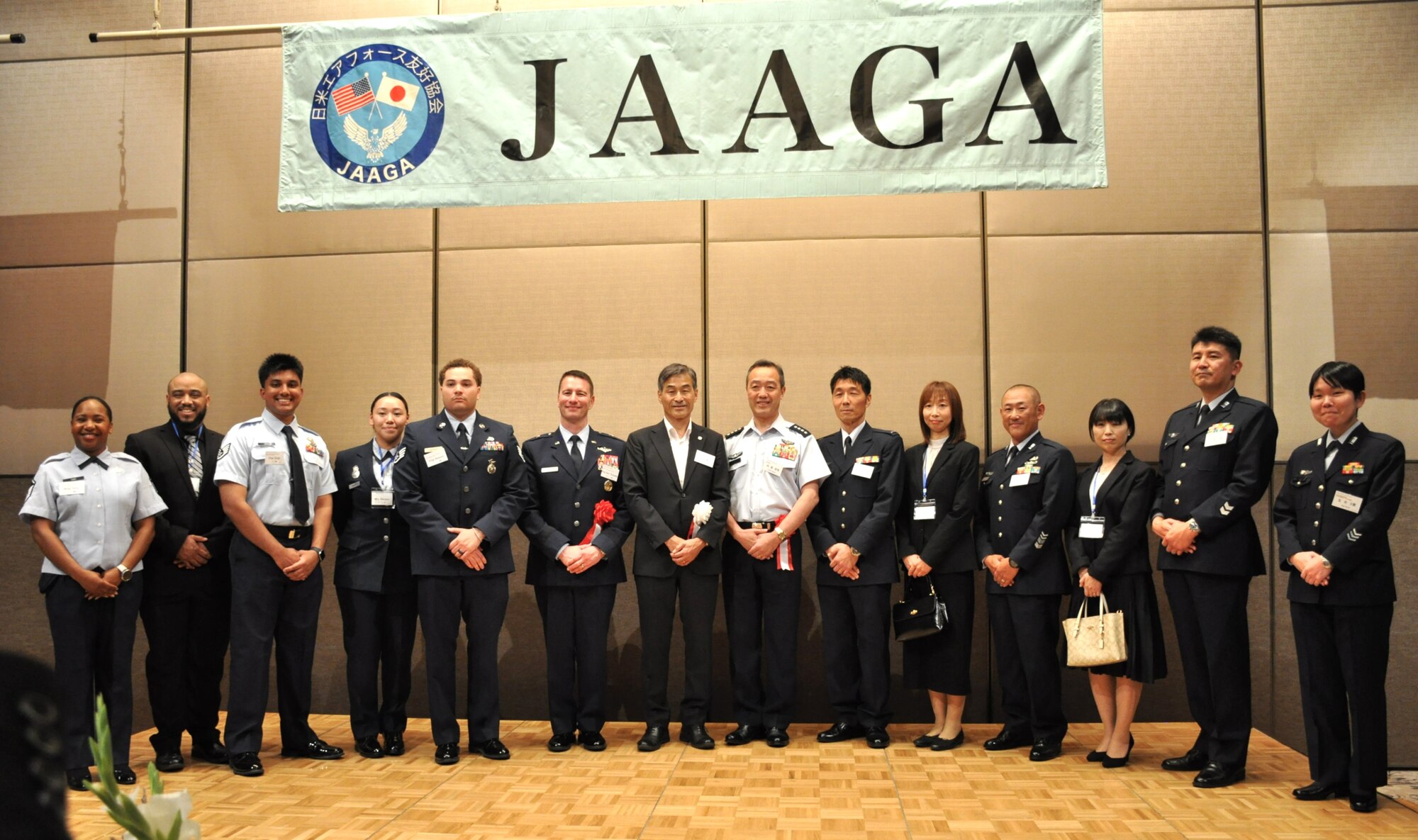 U.S. Air Force and Japan Air Self-Defense Force service members pose together for a photo with Mr. Yoshinari Marumo, Japan America Goodwill Association President, at Grand Hill Ichigaya, Japan, May 13, 2025. Service members were recognized for their contributions to further strengthen the alliance during bilateral and multilateral exercises and events. (U.S. Air Force photo by Capt Tisha Yates)