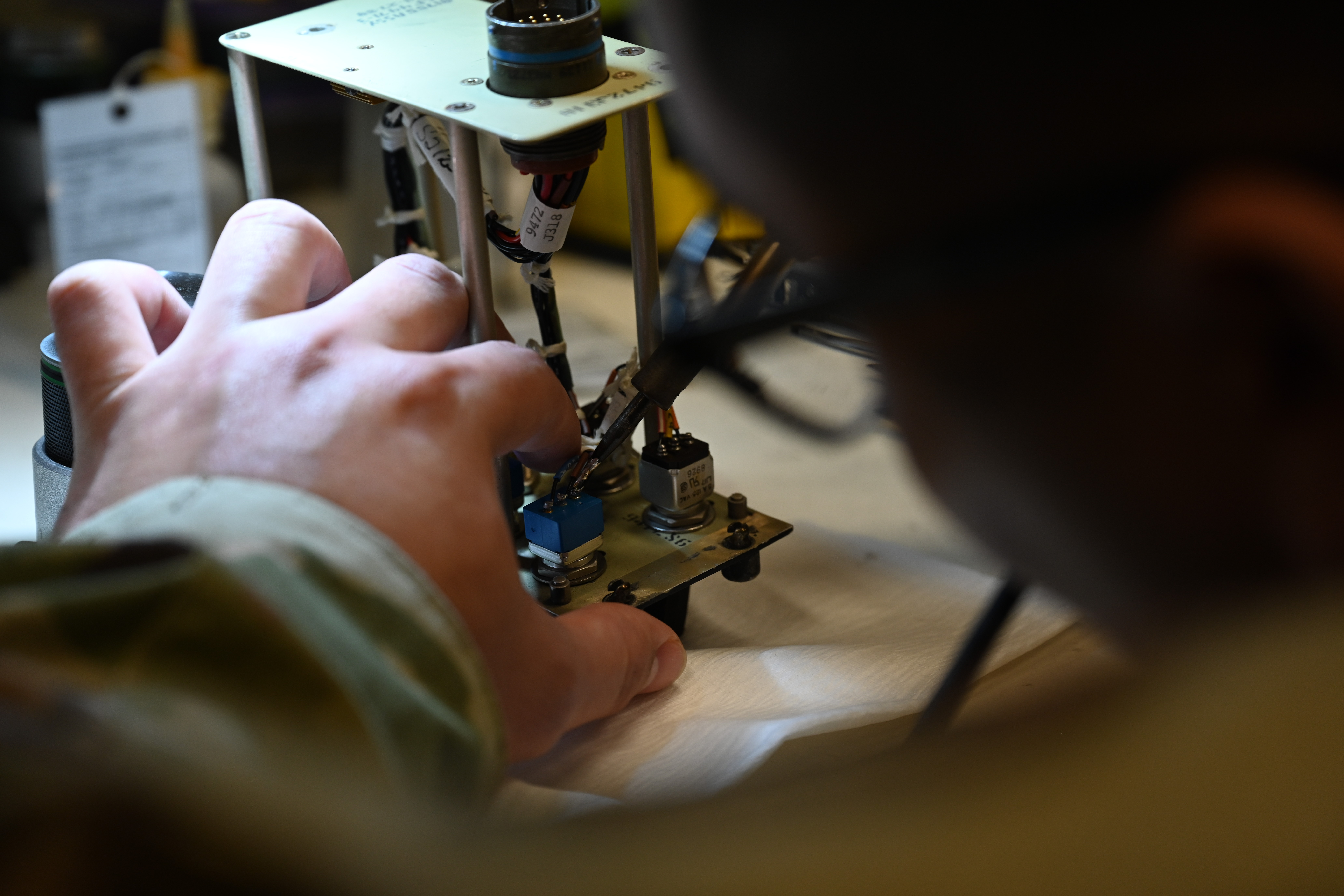 Senior Airman Michael Philip Flores-Rodriguez, 8th Maintenance Squadron AFREP technician, uses a solder to join metals on a fault function panel at Kunsan Air Base, Republic of Korea, May 25, 2025. The strategic approach within the AFREP program allows for maintainers to repair rather than replace equipment, a valuable resource that keeps essential components readily available without relying on external repair locations. (U.S. Air Force photo by Tech. Sgt. Giovanni Sims)