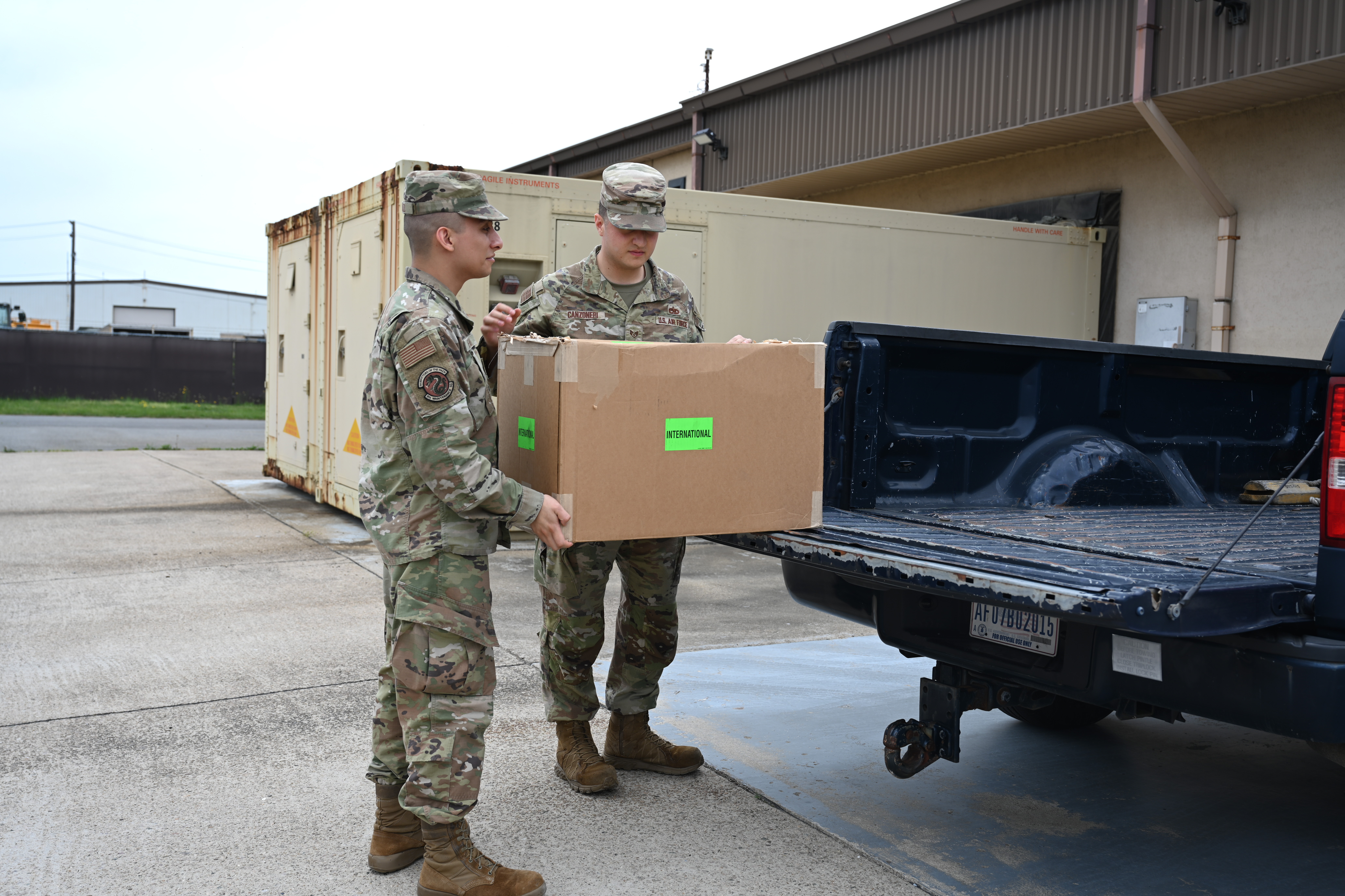 Senior Airmen Ernesto Nevado,, 8th Maintenance Squadron AFREP technician, and Air Force Staff Sgt. Anthony Canzoneri, 8th Maintenance Squadron AFREP non-commissioned officer in charge, carry a box supply assets for an Airtronics shipment at Kunsan Air Base, Republic of Korea, May 25, 2025. The strategic approach within the AFREP program allows for maintainers to repair rather than replace equipment, a valuable resource that keeps essential components readily available without relyihng on external repair locations. (U.S. Air Force photo by Tech. Sgt. Giovanni Sims)
