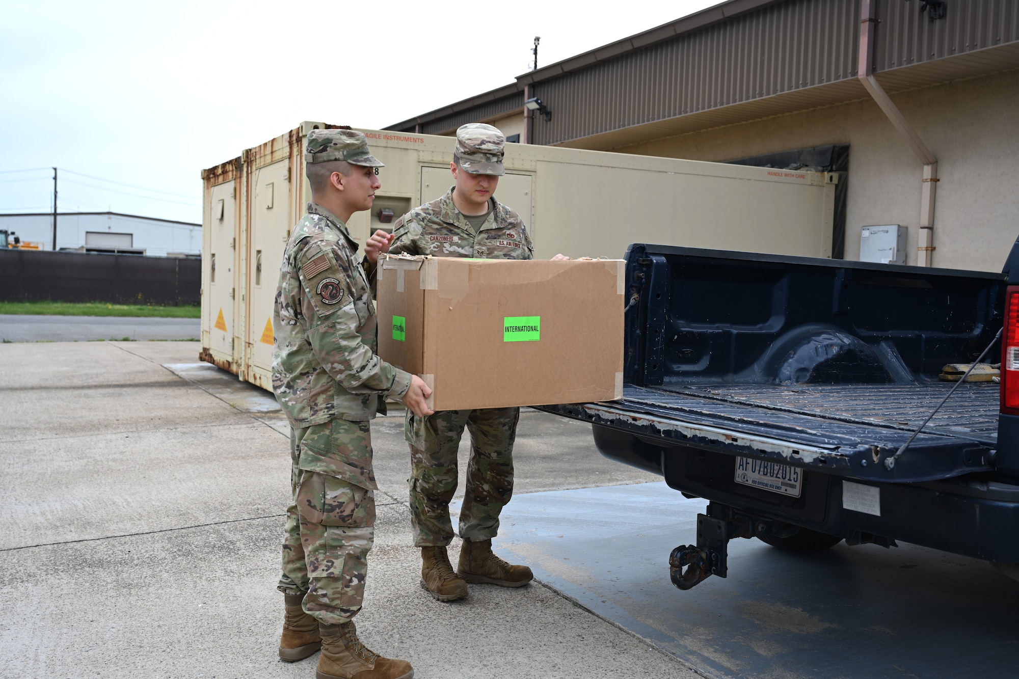 Senior Airmen Ernesto Nevado,, 8th Maintenance Squadron AFREP technician, and Air Force Staff Sgt. Anthony Canzoneri, 8th Maintenance Squadron AFREP non-commissioned officer in charge, carry a box supply assets for an Airtronics shipment at Kunsan Air Base, Republic of Korea, May 25, 2025. The strategic approach within the AFREP program allows for maintainers to repair rather than replace equipment, a valuable resource that keeps essential components readily available without relyihng on external repair locations.