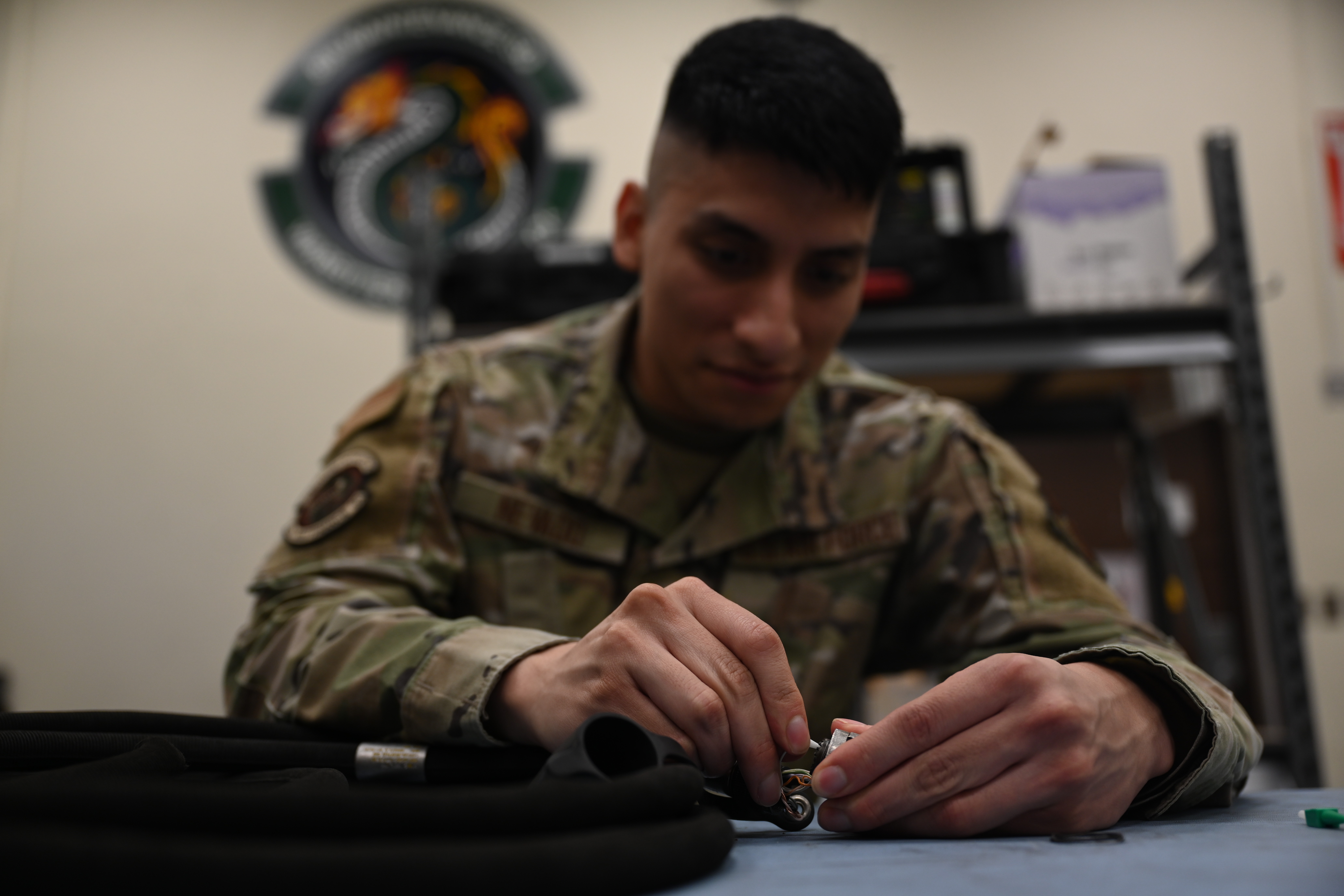 Senior Airman Ernesto Nevado, 8th Maintenance Squadron AFREP technician, swaps a connector head of a remote control unit cable at Kunsan Air Base, Republic of Korea, May 21, 2025. By prioritizing in-house repairs and salvaging condemned items, AFREP significantly reduces downtime and improves the availability of crucial parts. (U.S. Air Force photo by Tech. Sgt. Giovanni Sims)