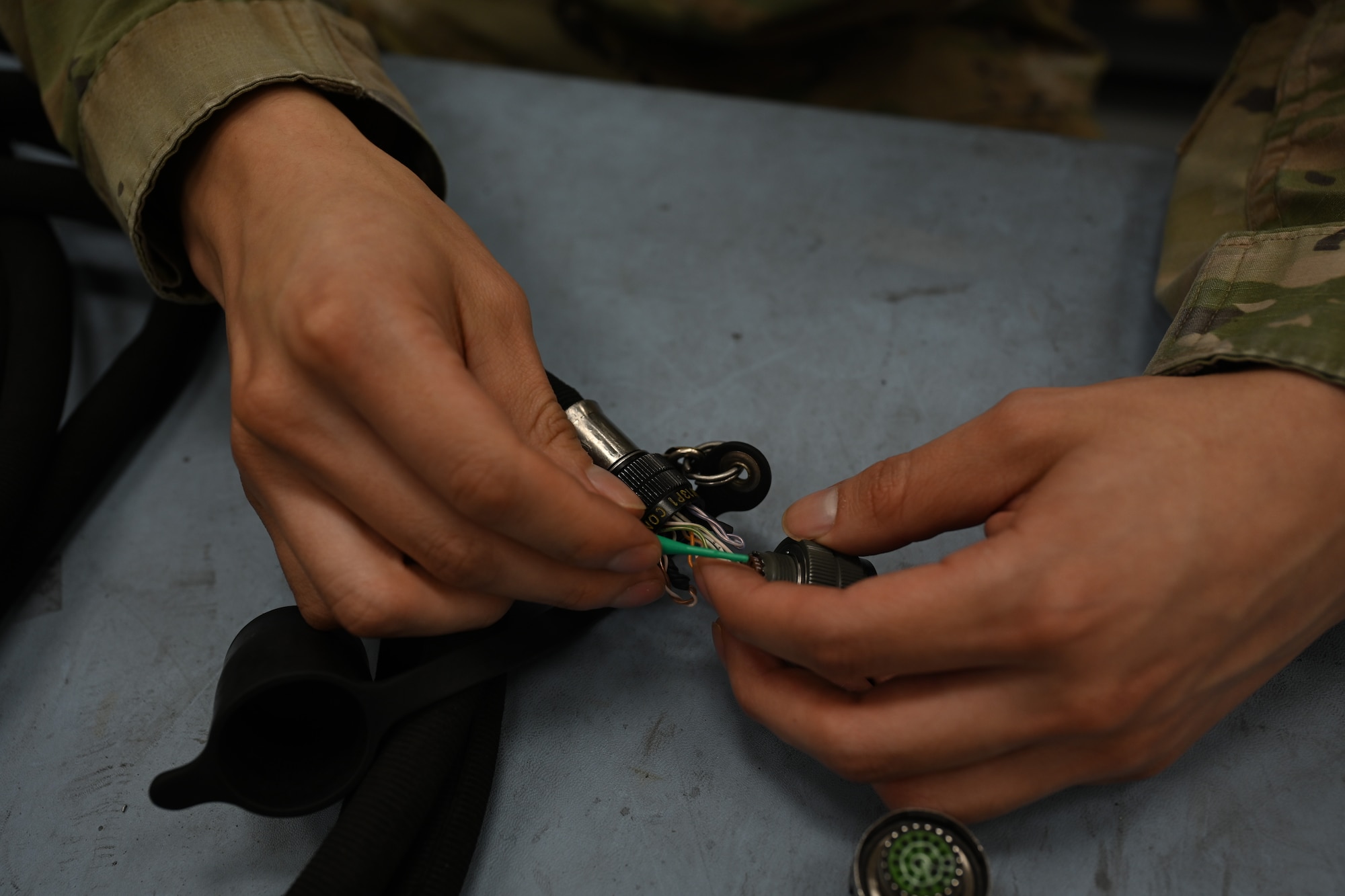 Senior Airmen Ernesto Nevado, 8th Maintenance Squadron AFREP technician, swaps a connector head of a remote control unit cable at Kunsan Air Base, Republic of Korea, May 21, 2025. By prioritizing in-house repairs and salvaging condemned items, AFREP significantly reduces downtime and improves the availability of crucial parts.
