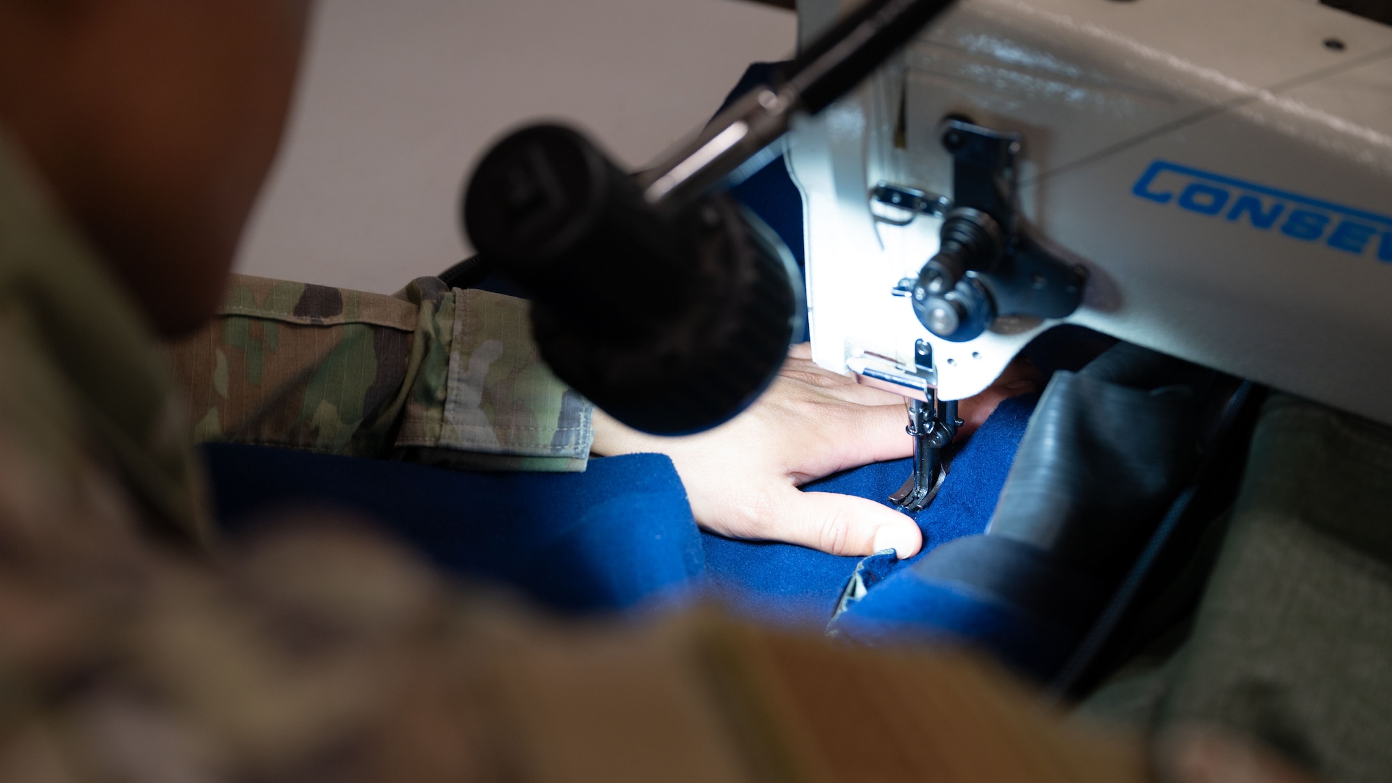 U.S. Air Force Senior Airman Keven Gomescoello, 51st Operations Support Squadron aircrew flight equipment technician, stitches a neck seal for an anti-exposure suit at Osan Air Base, Republic of Korea, May 22, 2025. Anti-exposure suits provide critical thermal protection for pilots flying over water, increasing survival time in the event of ejection or crash recovery. (U.S. Air Force photo by Senior Airman Rome Bowermaster)