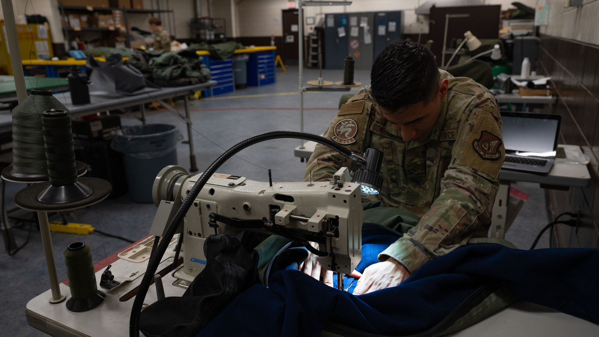 U.S. Air Force Senior Airman Keven Gomescoello, 51st Operations Support Squadron aircrew flight equipment technician, replaces a neck seal on an anti-exposure suit at Osan Air Base, Republic of Korea, May 22, 2025. Proper seal maintenance is vital to pilot safety during over-water missions by preserving warmth and buoyancy. (U.S. Air Force photo by Senior Airman Rome Bowermaster)
