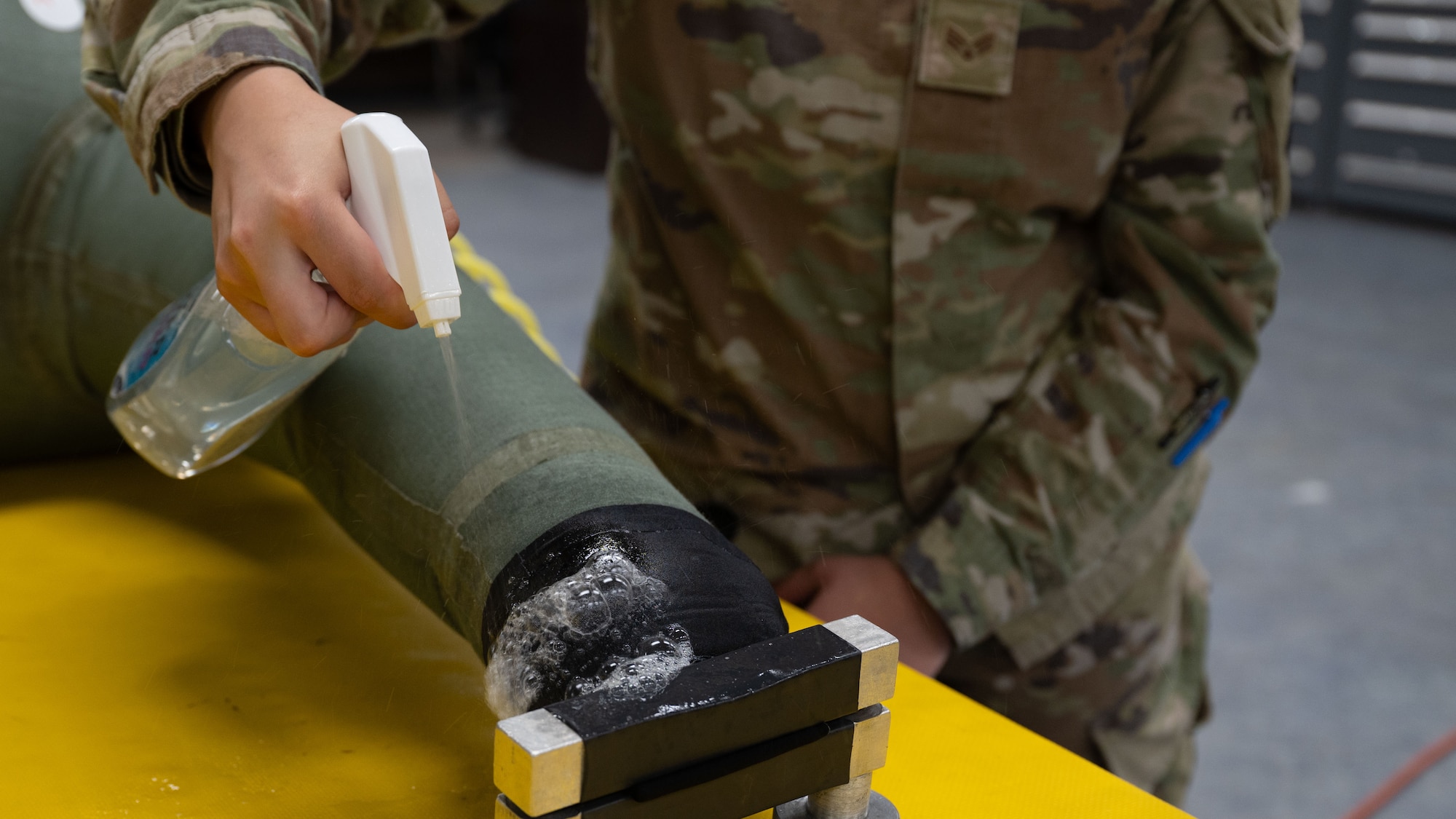 U.S. Air Force Senior Airman Meadow Brown, 51st Operations Support Squadron aircrew flight equipment technician, conducts a leak test at Osan Air Base, Republic of Korea, May 22, 2025. The test ensures that the suit remains serviceable, offering flotation and thermal protection during long-distance missions over water. (U.S. Air Force photo by Senior Airman Rome Bowermaster)