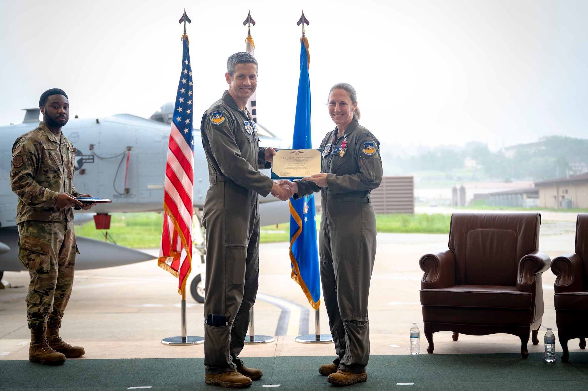 U.S. Air Force Col. Kathryn Gaetke, outgoing 51st Operations Group commander, receives the Legion of Merit award from Col. William McKibban, 51st Fighter Wing commander, during the change of command ceremony at Osan Air Base, Republic of Korea, May 22, 2025.