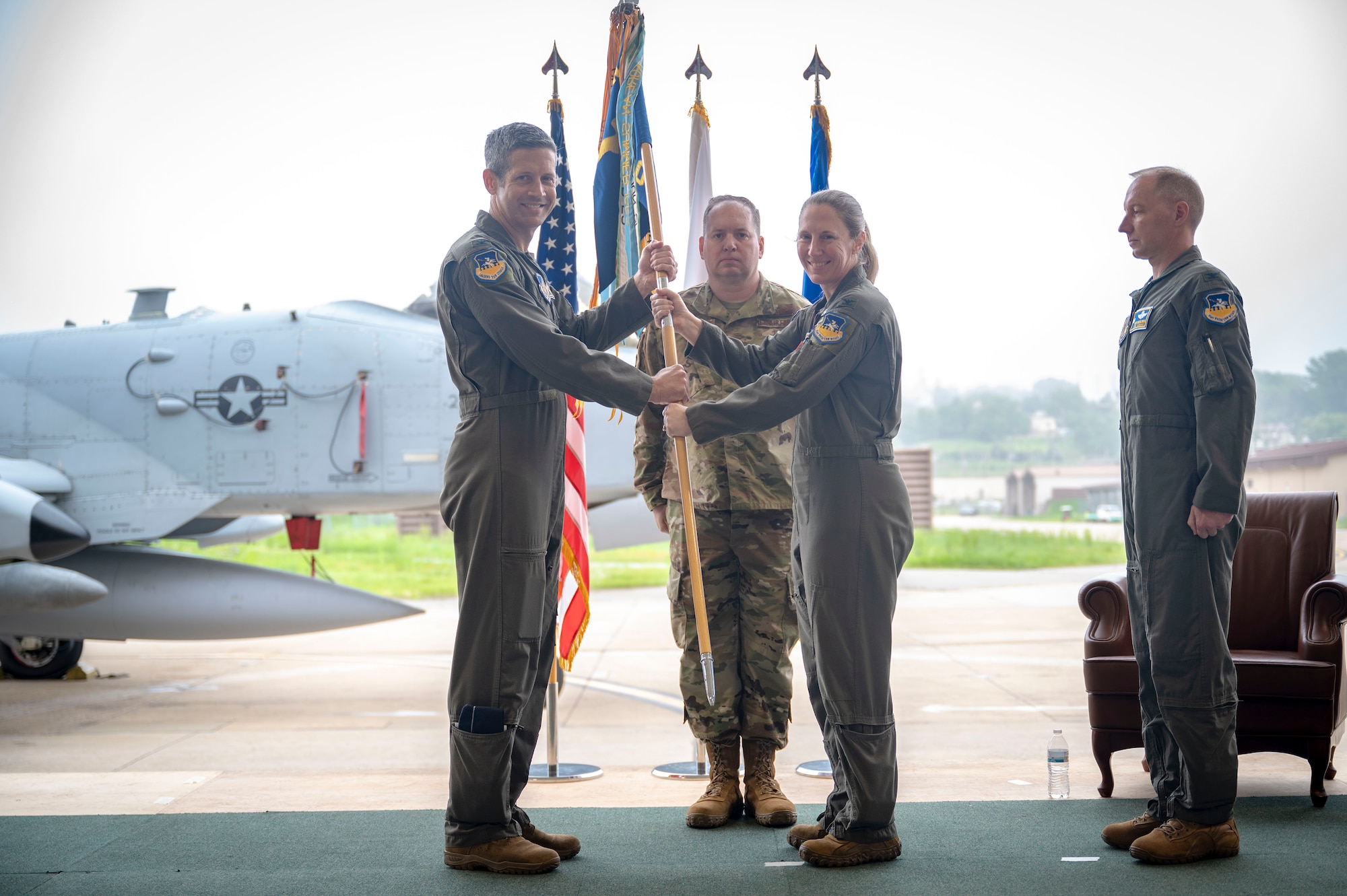 U.S. Air Force Col. Kathryn Gaetke, outgoing 51st Operations Group commander, passes the unit guidon to Col. William McKibban, 51st Fighter Wing commander, during a change of command ceremony at Osan Air Base, Republic of Korea, May 22, 2025.