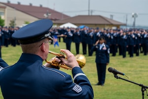 A military member plays the trumpet.