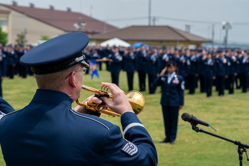 A military member plays the trumpet.