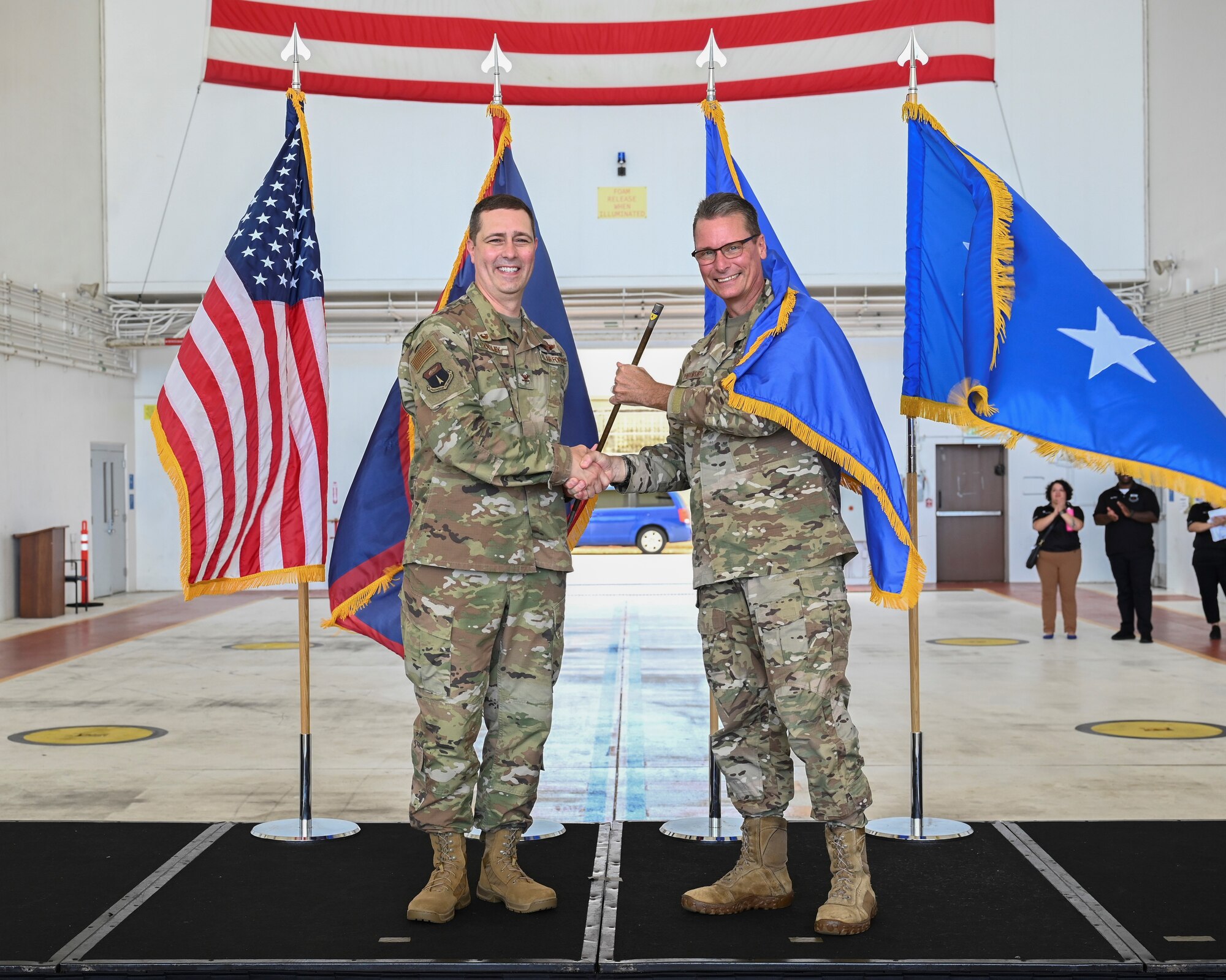 U.S Air Force Col. Charles Cooley, 36th Wing commander, (Left) and Brig Gen. Thomas Palenske pose for a photo during the 36th Wing change of command ceremony at Andersen Air Force Base, Guam, May 22, 2025. As a continued tradition, a “swagger stick” emblazed with the wing shield was presented and will be placed in the office of the wing commander. (U.S. Air Force photo by Airman 1st Class Joseph Maye)