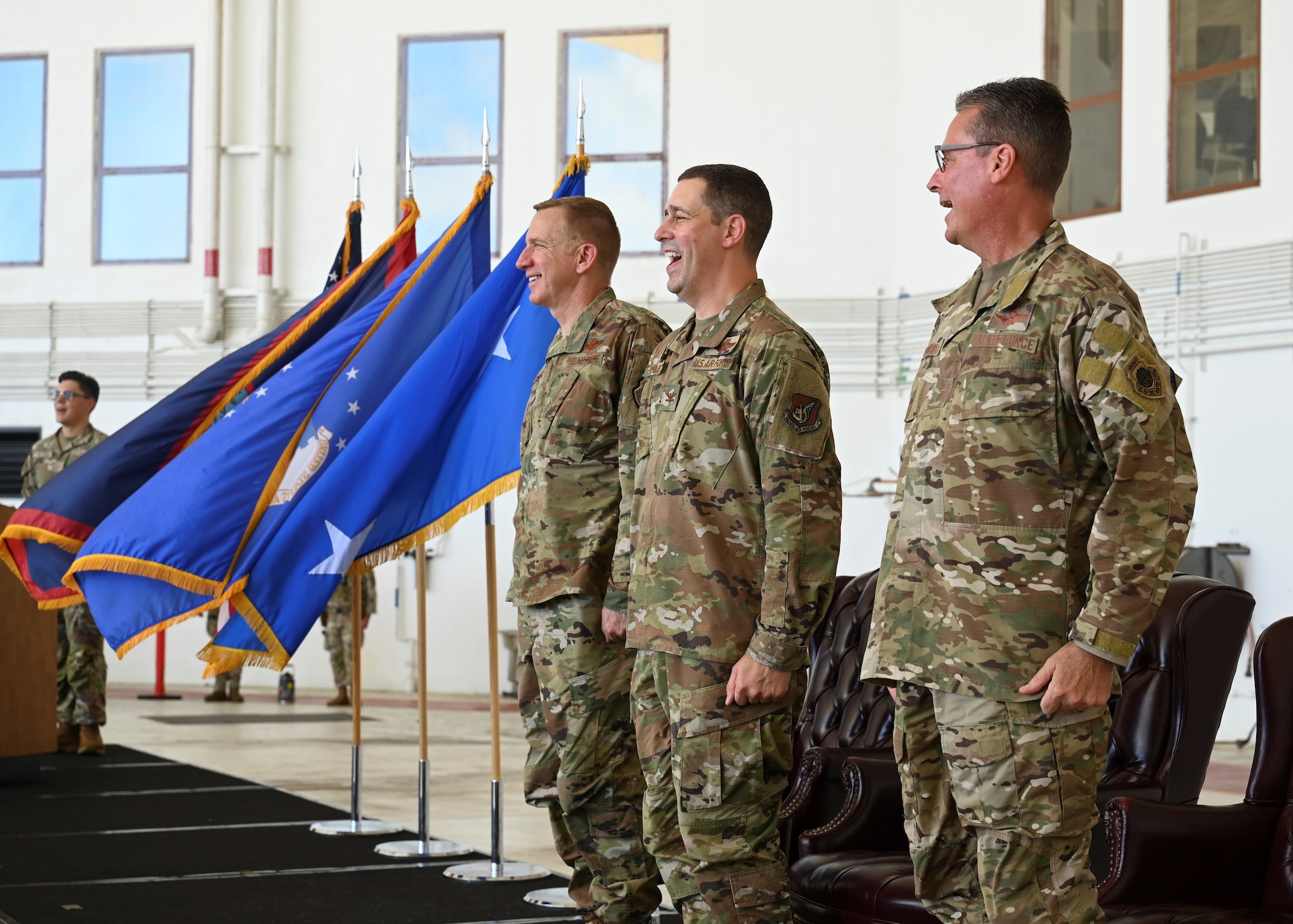 U.S. Air Force Lt. Gen. Case Cunningham, commander, 11th Air Force (Left), Col. Charles Cooley, 36th Wing commander (Middle), and Brig. Gen. Thomas Palenske (Right), stand at attention and sing the Air Force song during the 36th Wing change of command ceremony at Andersen Air Force Base, Guam, May 22, 2025. The song is sung to commemorate the service’s history and legacy. (U.S. Air Force photo by Airman 1st Class Joseph Maye)
