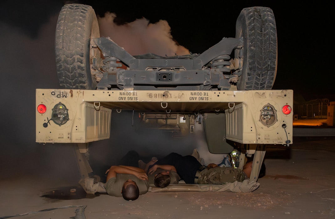 A rolled Humvee with simulated casualties laying in and near it are shown.