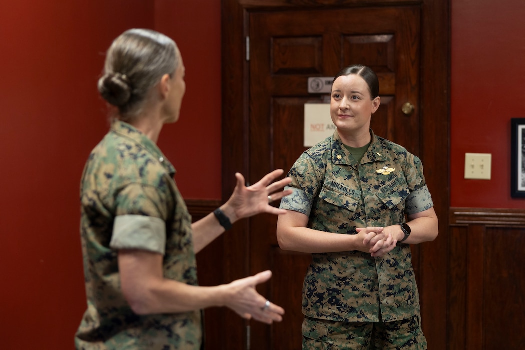U.S. Navy Lt. Cmdr. Natalie Nuckolls, right, an assitant dental officer with 2nd Dental Battalion,  2nd Marine Logistics Group, is congratulated by U.S. Marine Corps Brig. Gen. Maura M. Hennigan, commanding general, 2nd MLG for being selected as the 2025 Liz Blanc Sexual Assault Prevention and Response Victims Advocate of the Year at Marine Corps Base Camp Lejeune, May 19, 2025. Each year, the Department of Defense recognizes individuals from each military service who are selected as the Exceptional Sexual Assault Response Coordinator for their branch. Nuckolls was selected due to her renovation of the Combat Logistics Battalion 8, Combat Logistics Regiment 2, 2nd MLG, SAPR Program, where she established a quick response code for SAPR resources and a memorandum of understanding within the regiment, ensuring consistent SAPR operations and protocols that positively impacted all units within 2nd MLG. (U.S. Marine Corps photo by Lance Cpl. Isabella Ramos)
