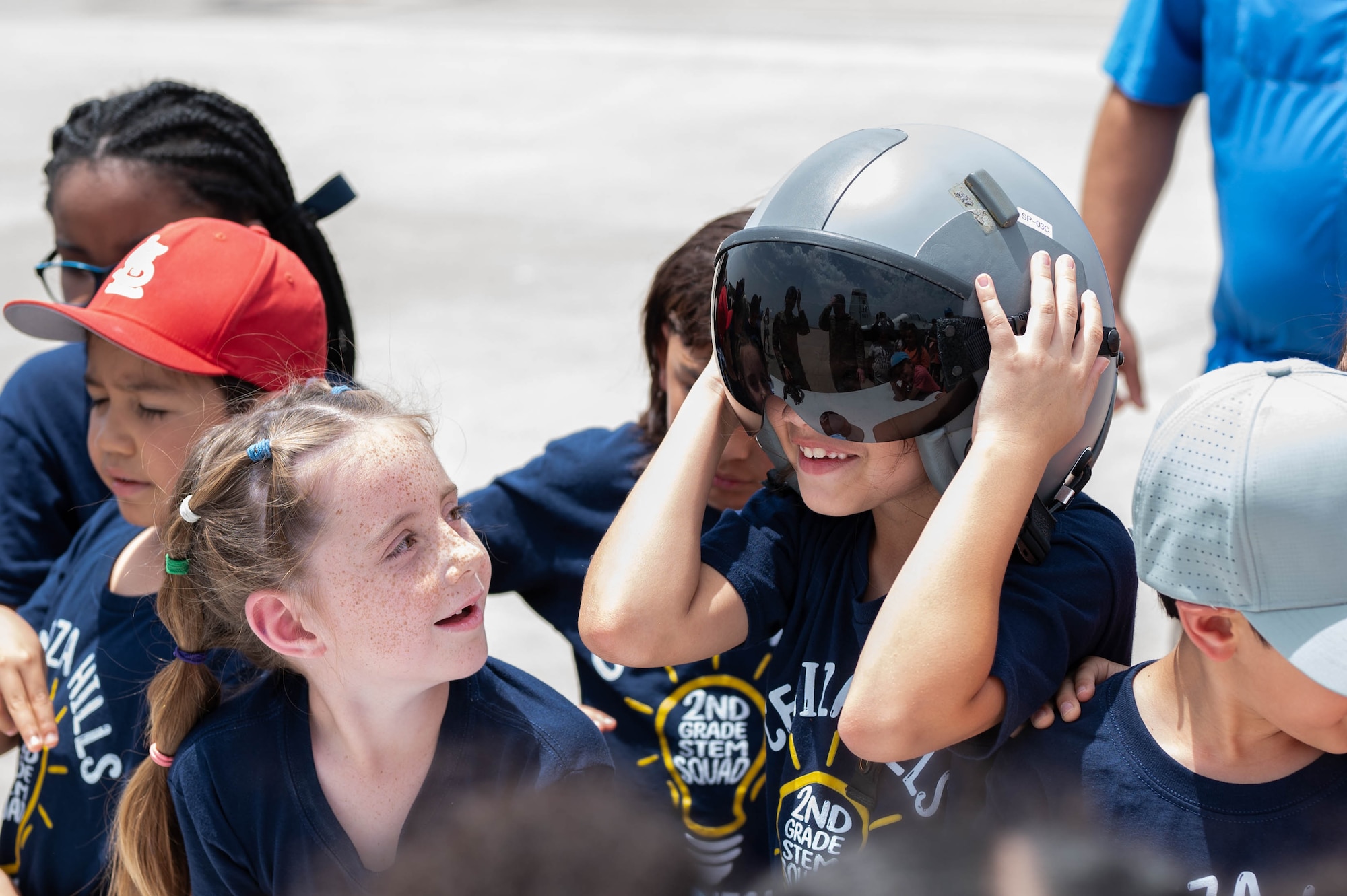 A student tries on a flight helmet during a Ceniza Hills School tour at Laughlin Air Force Base, Texas, May 15, 2025. Attendees were given hands-on access to aircrew flight equipment and were briefed on pilot operations. (U.S. Air Force photo by Senior Airman Keira Rossman)