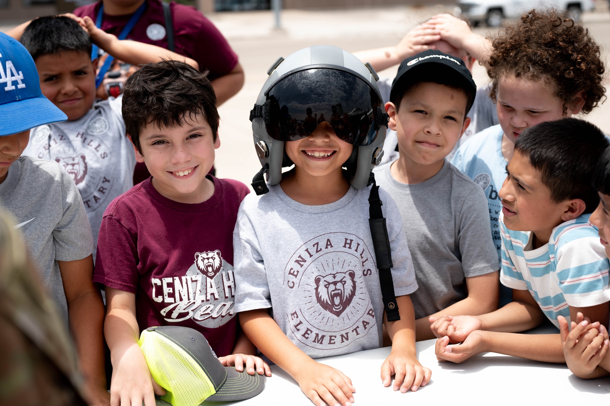 Students from Ceniza Hills Elementary smile for a photo while exploring flight gear during a Ceniza Hills School tour at Laughlin Air Force Base, Texas, May 15, 2025. The event encouraged curiosity and introduced youth to Air Force careers. (U.S. Air Force photo by Senior Airman Keira Rossman)