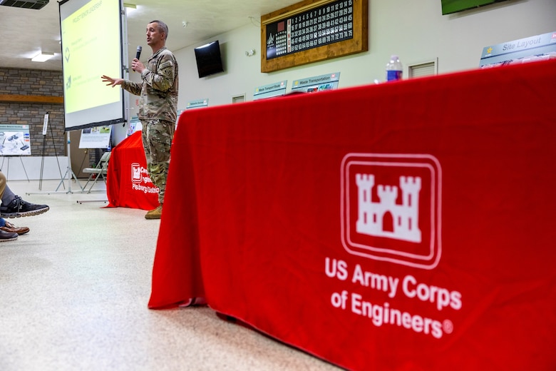 A man speaks to a crowd in an event hall.