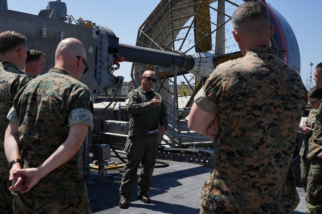 U.S. Navy Senior Chief Petty Officer Jason Lopez, landing craft, air cushion (LCAC) craft master assigned to Assault Craft Unit (ACU) 5, informs U.S. Marines with the 11th Marine Expeditionary Unit, I Marine Expeditionary Force, about the components of an LCAC at Marine Corps Base Camp Pendleton, California, May 19, 2025.