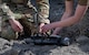 Senior Airman Arthur Pancoast, 5th Civil Engineer Squadron Explosive Ordnance Disposal (EOD) Journeyman, (left), and Capt. Natalie Petro, EOD flight commander, (right), prepare a shape charge to be detonated remotely at Minot Air Force Base, North Dakota, May 12, 2025. The event aimed to train new Airmen for the EOD flight in detonating shape charges and observe their effects. (U.S. Air Force photo by Airman 1st Class Wesley Davies)