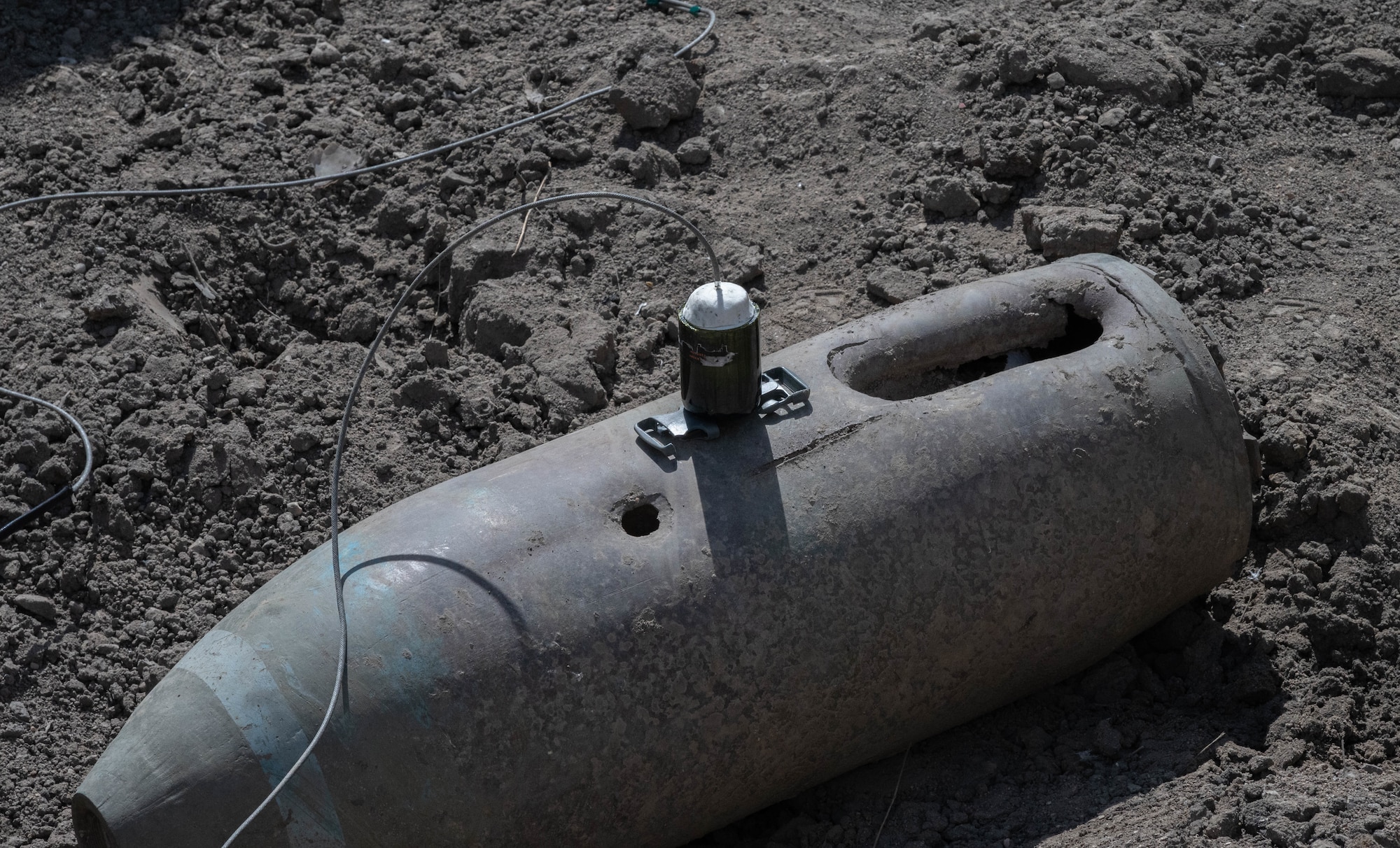 An improvised shape charge setup on an inert munition training material for a training event at Minot Air Force Base, North Dakota, May 12, 2025. An improvised shape charge is used during training to help Airmen distinguish what impact the material used can have on an explosive. The EOD flight is tasked with  neutralizing hazards associated with explosive ordnance that pose a threat to people, installations, and operations.  (U.S. Air Force photo by Airman 1st Class Wesley Davies)