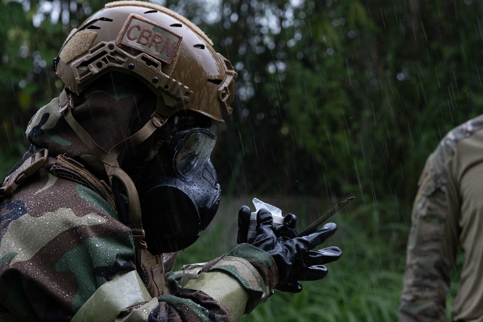U.S. Air Force Staff. Sgt. Chastilynn Tittle, an emergency management specialist with the 154 Civil Engineer Squadron, Hawaii Air National Guard, examines a chemical explosive substance during the 2025 Virgin Islands and Puerto Rico emergency management Deployment for Training at Fort Allen, Juana Diaz, Puerto Rico, May 18, 2025. The 2025 VIPR EM DFT measured multiple ANG civil engineer squadrons’ mission readiness by simulating an austere location to prepare participating Airmen to execute the Agile Combat Employment Concept within the U.S. Air Force Indo-Pacific Command area of responsibility. (U.S. Air National Guard photo by 1st Lt. Eliezer Soto)