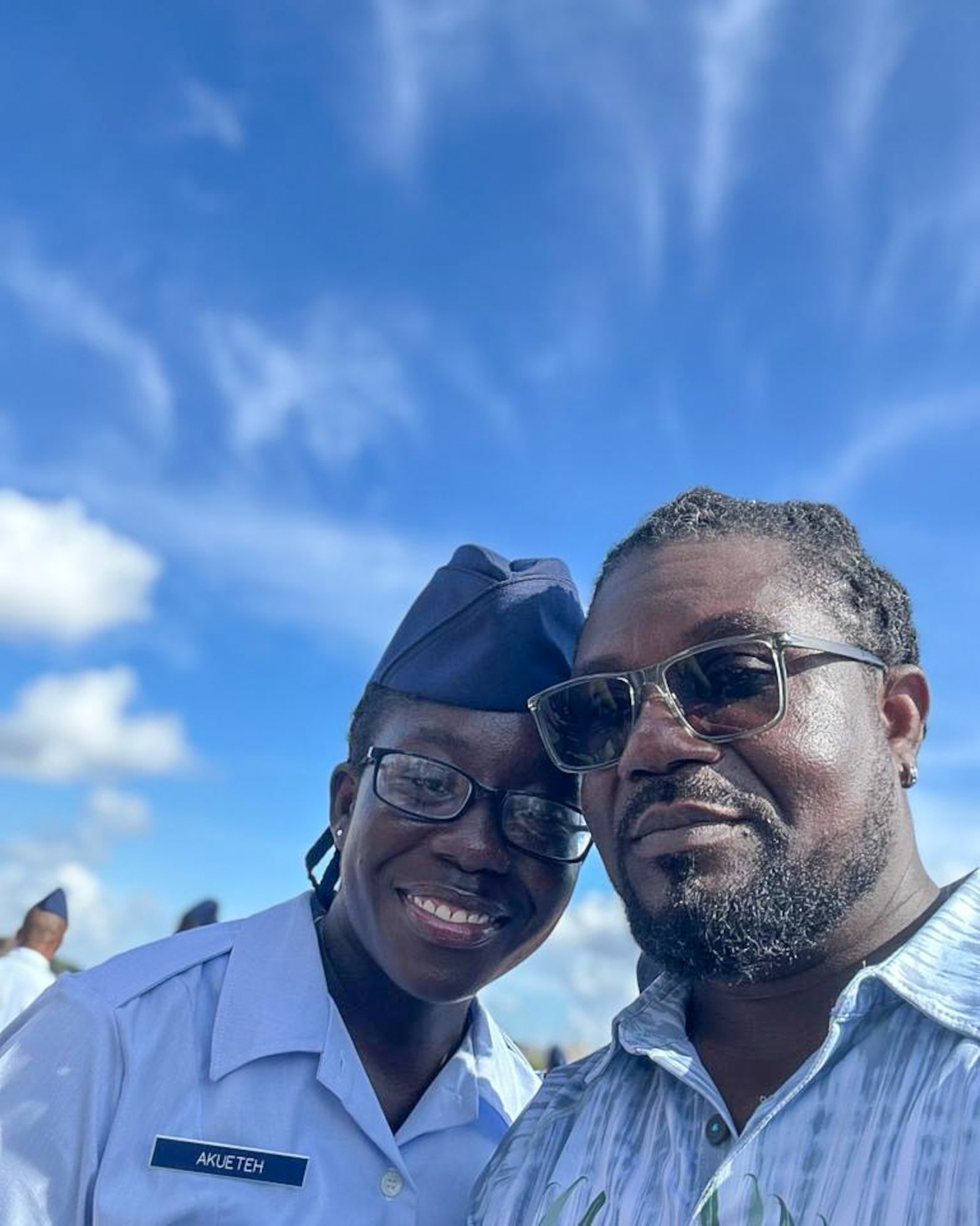 U.S. Air Force Airman 1st Class Angel Akueteh, 42nd Force Support Squadron customer support technician, poses for a photo with her father during her Basic Training Graduation at Joint Base San Antonio-Lackland, Texas, Oct. 7, 2023.