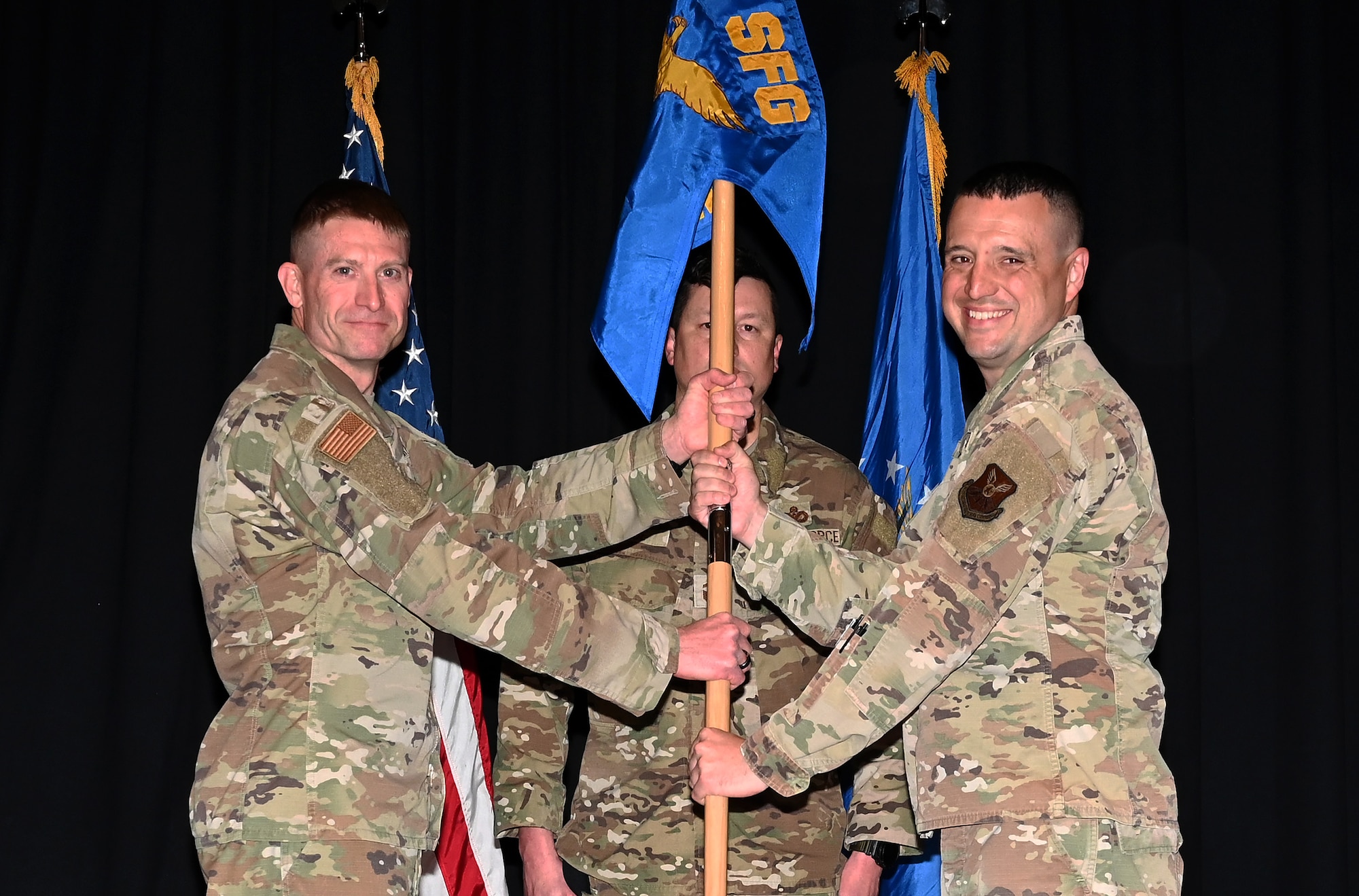 The Security Forces Group commander passing the squadron guideon to the new squadron commander.